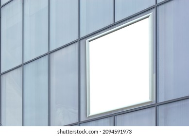 Rectangular Sign On The Building. Copy Space And Space For Text. Mockup For Design. Blank Template For Advertising. White Frame On A Glass Case. Advertising On The Window Of The Mall.