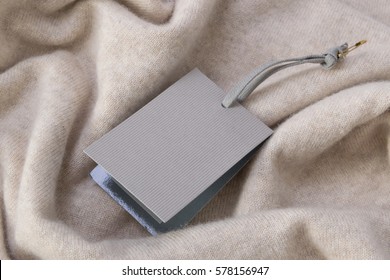 Rectangular Tag On A Beige Cashmere Sweater