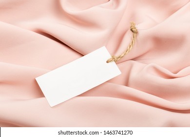 Rectangular Tag On A Clothes. Fashion, People And Shopping Concept - Close Up Price Tag Of Clothing Item