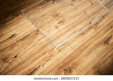 Rectangular trapdoor concealed in hardwood floor