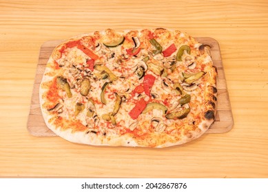 Rectangular Vegetable Pizza With Roasted Red Bell Pepper, Green Bell Pepper, Zucchini And Mushrooms Topped With Mozzarella Cheese And Tomato