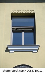 a rectangular window with a spread window sill and a decorated upper edge