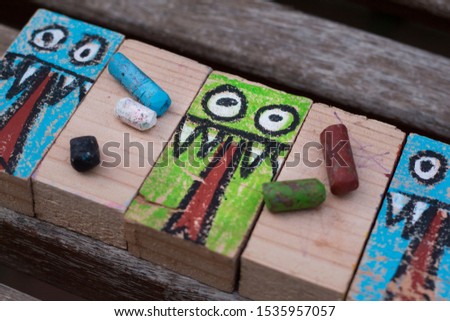 rectangular woods painted with a monster drawing for Halloween