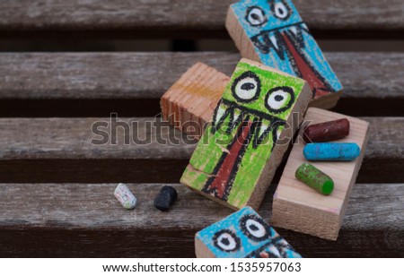 rectangular woods painted with a monster drawing for Halloween