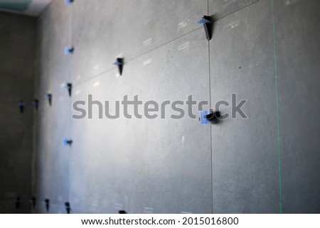 rectified background tiles in rustic stone tiles in grey color