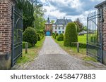 Rectory of the Sint-Martinus parish with gate and garden, Wezemaal, Hageland, Belgium.