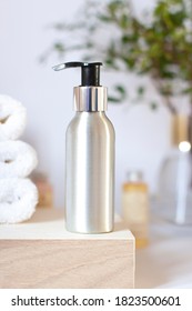 Recyclable Metallic Cosmetic Face Cleanser Bottle With Pump In The Bathroom Close Up. Body Wash Concept