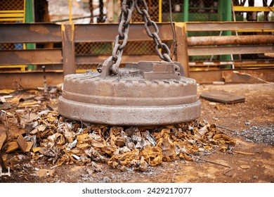 Recycle, metal and rust on magnet in junkyard for sorting, garbage and scrap reuse at landfill site. Steel, iron and industrial electromagnet excavator for urban pollution at waste dump with machine - Powered by Shutterstock