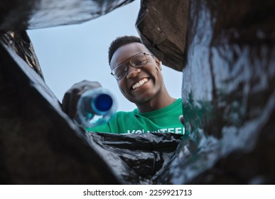 Recycle, smile and black man with view in bag, sustainability and cleaning plastic pollution, earth day and help in community. Saving the environment, charity and people putting trash in garbage bin. - Powered by Shutterstock