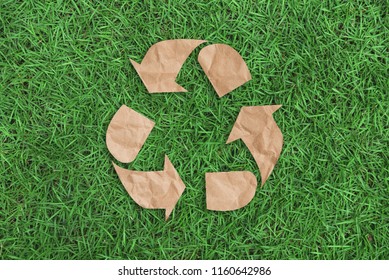 recycle symbol on green grass background top view. eco and save the earth concept. - Shutterstock ID 1160642986