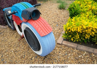 Recycle tires wheel to colorful motorcycle on sand ground, paint the color  for children or kids to play  at playground. Concept create value from the waste. - Powered by Shutterstock