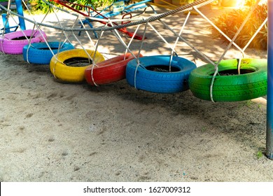 Recycle tires wheel on sand ground, paint the color used bridge with rope for children or kids walk and balance body to play at playground.Concept create value from the waste.