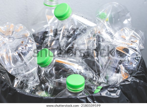 Recycled clear\
plastic bottles on gray\
background