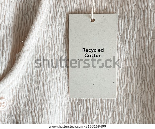Recycled cotton\
fashion label tag, sale price card on luxury fabric background,\
shopping and retail\
concept