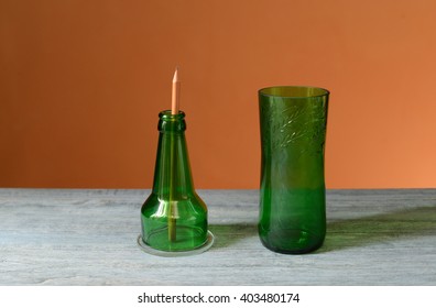 Recycled Glass Bottle As A Pencil Holder On The Table