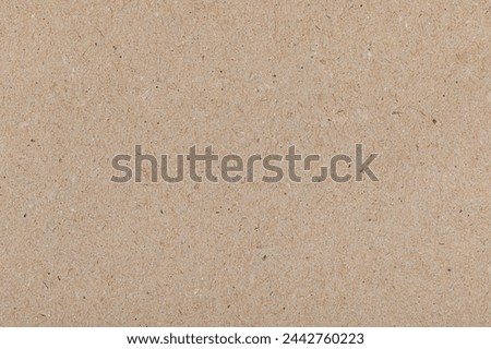 Recycled kraft paper textured surface with colorful flecks and natural fibers