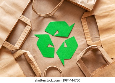 Recycled packaging ,craft packages for packaging goods from online stores, eco friendly packaging made of recyclable raw materials, green arrow recycling symbol - Shutterstock ID 1994444750