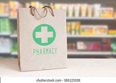 Recycled paper bag with a green Pharmacy logo in a drugstore. Empty copy space for Editor's content..