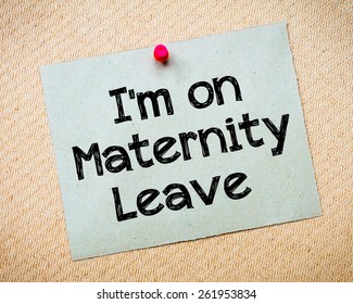 Recycled paper note pinned on cork board.I'm on Maternity Leave Message. Concept Image
