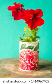 Recycled Tin Can Planter Whith Red Flowers.