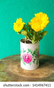 Recycled Tin Can Planter Whith Yellow Flowers.