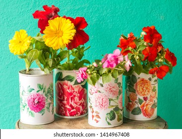 Recycled Tin Cans Planters Whith Red And Yellow Flowers.