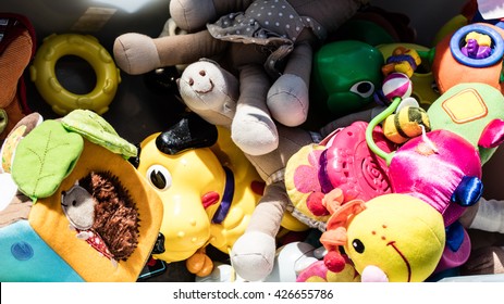 Recycling Baby Toys And Teddies Made Of Cheap Plastic Or Fabric In Bulk Display At Garage Sale Of Flea Market For Over-consumption Society, Outdoors