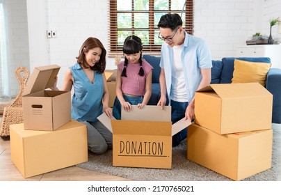 Recycling, Donation for poor, smiling asian family pack, holding donate box full with second hand clothes, charity helping and needy people. Reuse recycle. - Powered by Shutterstock