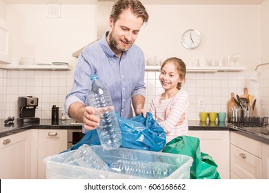 Recycling and ecology - happy caucasian family (father and daughter) sorting (segregating) household waste in the kitchen. Lifestyle - ecological education and awareness concept. - Powered by Shutterstock