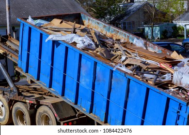recycling garbage collector truck loading waste and removable container.
