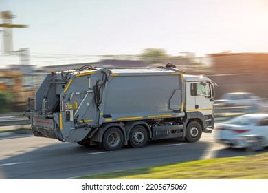 Recycling Gray Garbage Truck Driving On Highway With Motion Blur Speed Effect