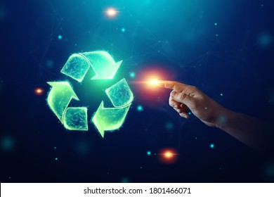 Recycling hologram sign on a blue background. Green eco recycling symbol and human hand. The concept of clean land, garbage disposal - Shutterstock ID 1801466071