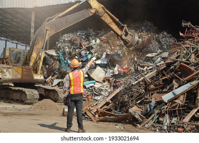Recycling industry a worker who recycling thing on recycle center.Manager and Manual Worker in Metal Landfill - Shutterstock ID 1933021694