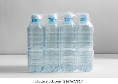 Recycling, Packing And Storage Concept - Close Up Of Plastic Bottles With Pure Drinking Water On Table