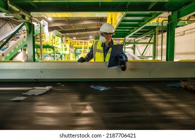 Recycling Plant Solid Waste Management Engineer Checking on Running Trash Material Conveyor. Making Documentation. - Shutterstock ID 2187706421