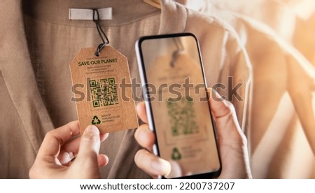 Recycling Products Concept. Organic Cotton Recycled Cloth. Zero Waste Materials. Environment Care, Reuse, Renewable for Sustainable Lifestyle. Using Mobile Phone to Scan on Tag for more Information