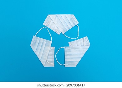 Recycling symbol is made of face masks. Concept - medical garbage. Problem of waste disposal resulting from the Covid-19 coronavirus pandemic. Environmental protection. - Shutterstock ID 2097301417