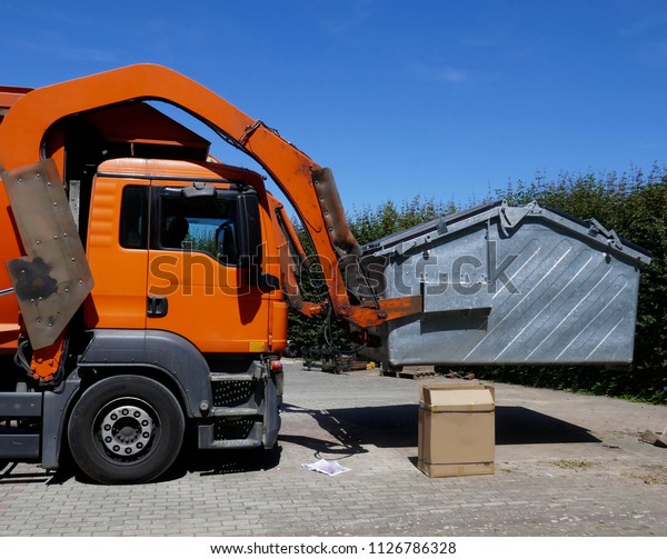 Recycling vehicle, truck, a heavy commercial\
vehicle at work\
