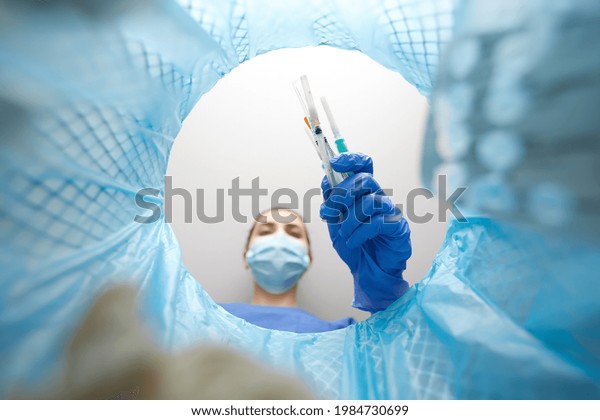 recycling, waste sorting and sustainability concept -\
doctor or healthcare worker in gloves throwing used syringes into\
trash can
