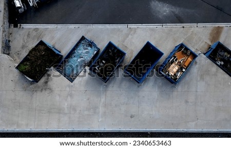 recycling yard with a ramp for dumping and sorting waste into containers. glass. Materials such as glass, metal, wood have their own boxes. vertical view from above