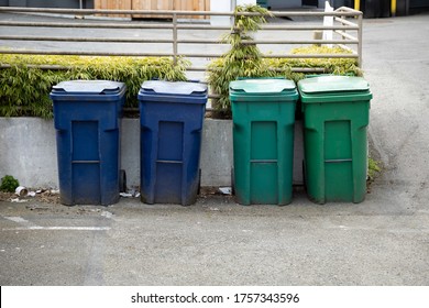 Recycling And Yard Waste Bins In An Alley