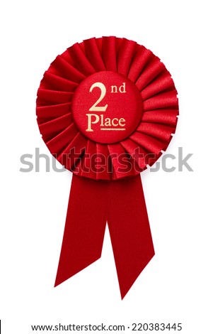 Red 2nd place ribbon rosette with gold central text in a pleated surround isolated on white