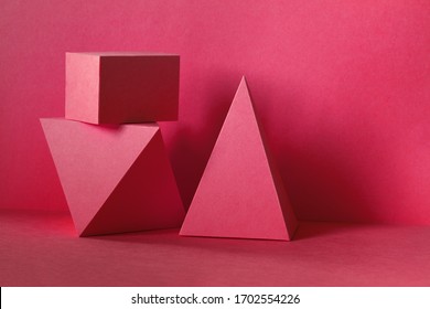 Red abstract geometrical figures background. Beautiful three-dimensional pyramid rectangular cube objects. Platonic solids figures, simplicity concept photography.