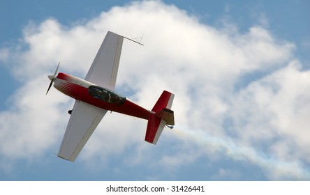 Red acrobatic plane in action.