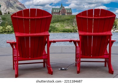 Red Adirondack Chairs (defocused) At Waterton Lakes National Park, In Canada During Summer