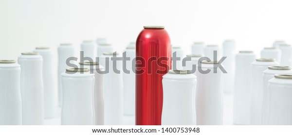 red aerosol can between white aerosol cans on\
white background