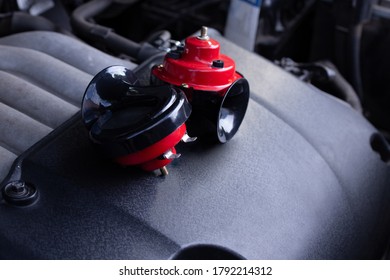 Red air horn for a car on a car engine. Electric Car air horn.