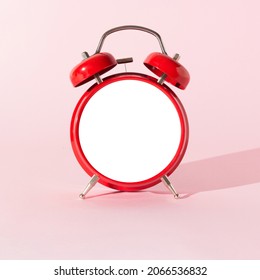 Red alarm clock with empty space on pink pastel background. Copy space for morning messages. Minimal concept. Wake up call.