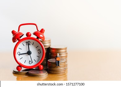 Red Alarm Clock On Stack Of Coins In Concept Of Savings And Money Growing Or Energy Save. Business Investment Growth Concept. Retirement And Pension. Time Is Money Concept.