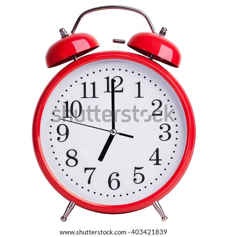 Red alarm clock shows exactly seven o'clock